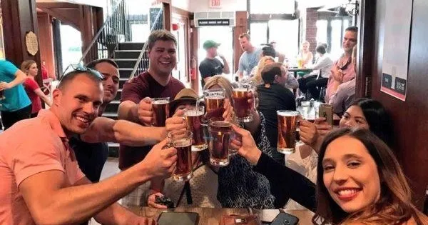 a group of people holding wine glasses