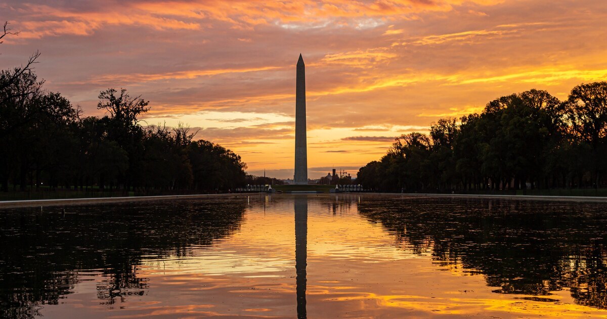 Washington Monument reflected in the Lincoln Memorial Reflecting Pool at sunset in Washington, D.C.